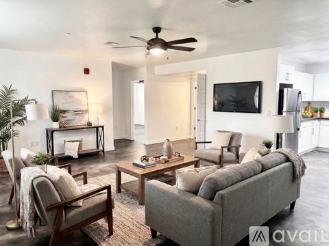 A living room with a grey couch and a wooden coffee table.