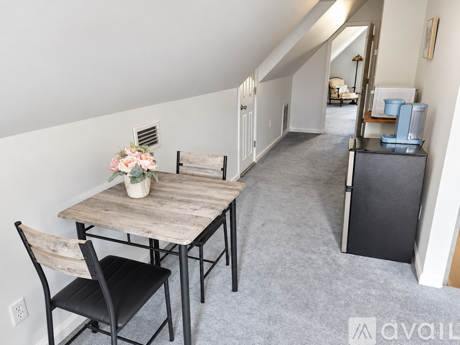 A dining room with a wooden table and chairs.