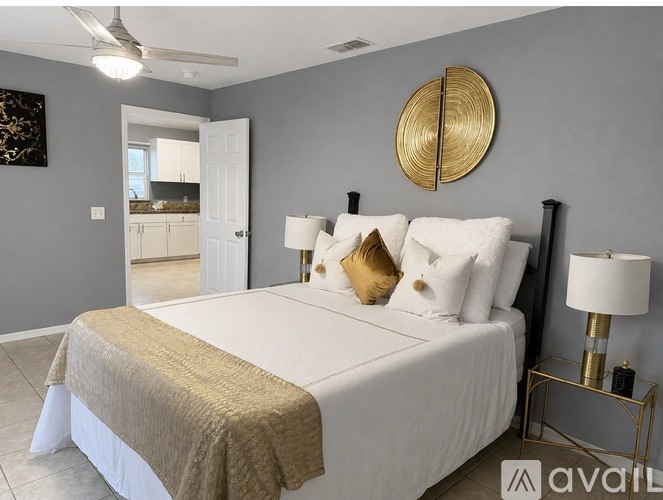 A bedroom with a large bed and a mirror on the wall.