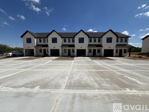 A large white building with a parking lot in front.