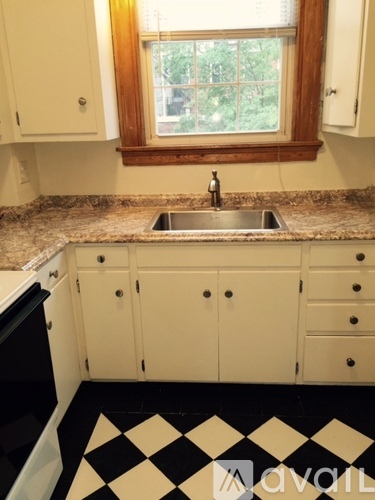 A kitchen with a sink and a window.