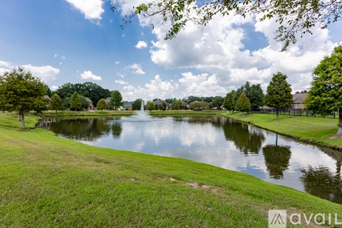 A serene park with a pond and trees.