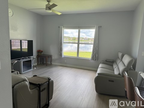 A living room with a television, a couch, and a table.
