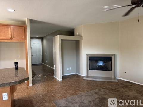A living room with a fireplace and a television.