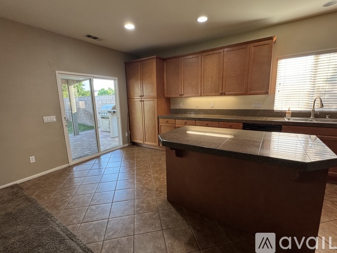 A kitchen with a countertop and cabinets is available for rent.