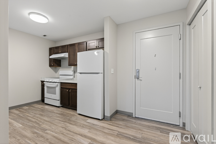 A kitchen with a white refrigerator, white oven, and white stove.
