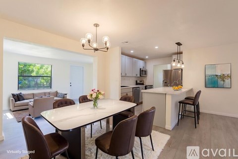 A modern dining room with a large table and chairs.
