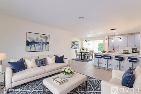 A living room with a white couch and a coffee table in front of it.