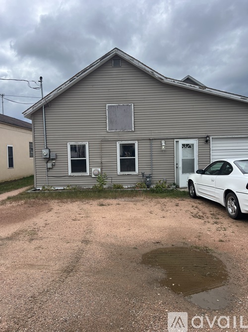 A house with a car parked in front of it.