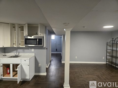 A kitchen with white cabinets and a microwave above the stove.