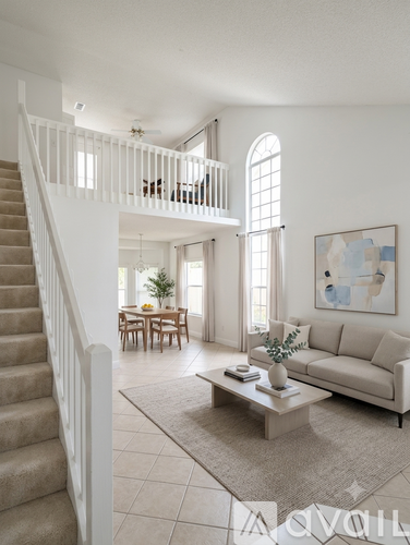 A living room with a staircase leading to the upper floor.