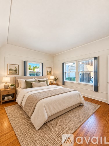 A bedroom with a large bed and a window overlooking a cityscape.