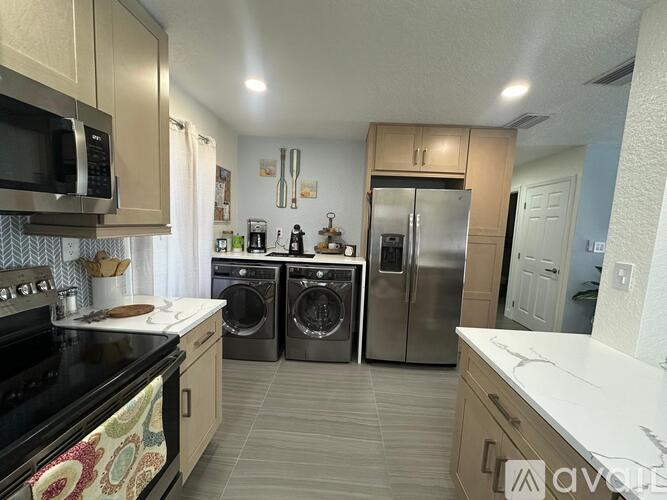 A kitchen with a black stove top oven and a black microwave.