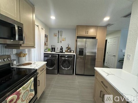A kitchen with a black stove top oven and a black microwave.
