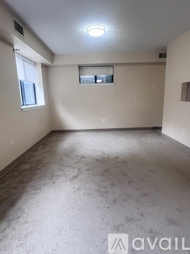 A room with a window and a ceiling light.