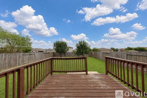 A wooden deck leads to a grassy area.