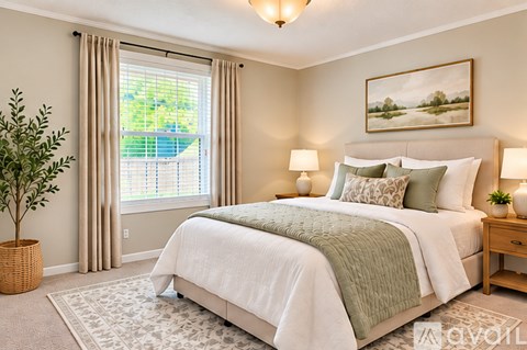A bedroom with a large bed and a painting on the wall.