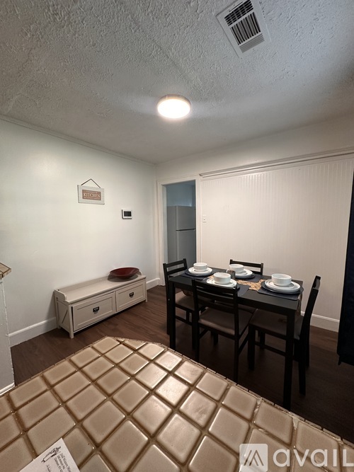 A dining area with a table set for four.