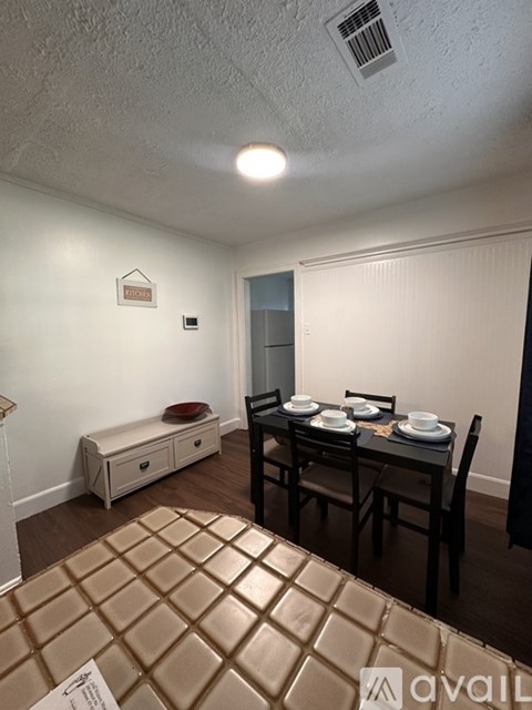 A dining area with a table set for four.