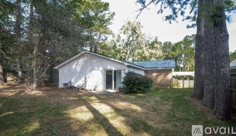 A house with a yard and trees around it.