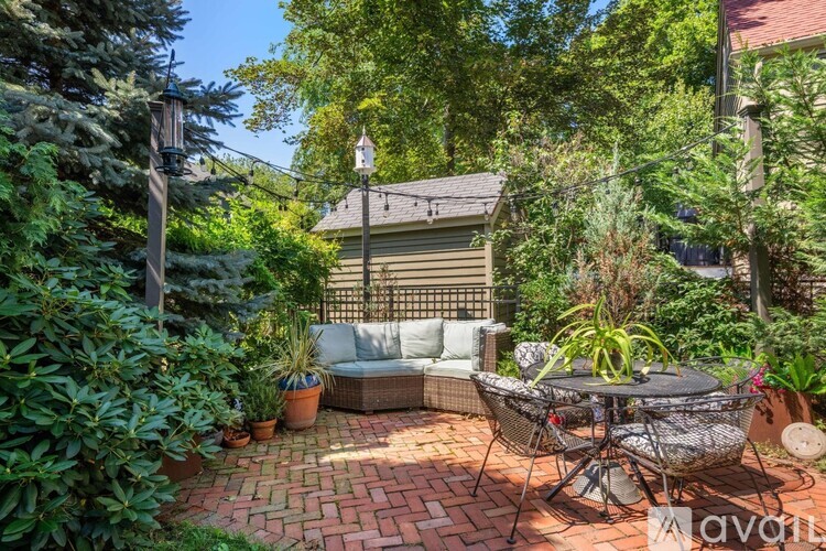 A backyard with a patio, table, and chairs.