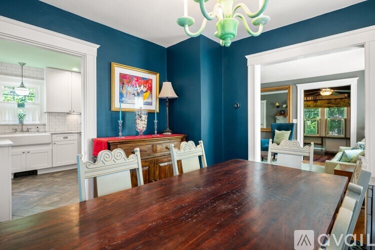 A dining room with a wooden table and chairs.