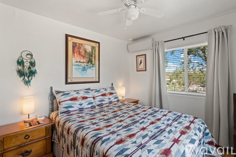 A bedroom with a large bed and a painting on the wall.