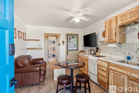 A kitchen with a table and chairs in the middle of the room.