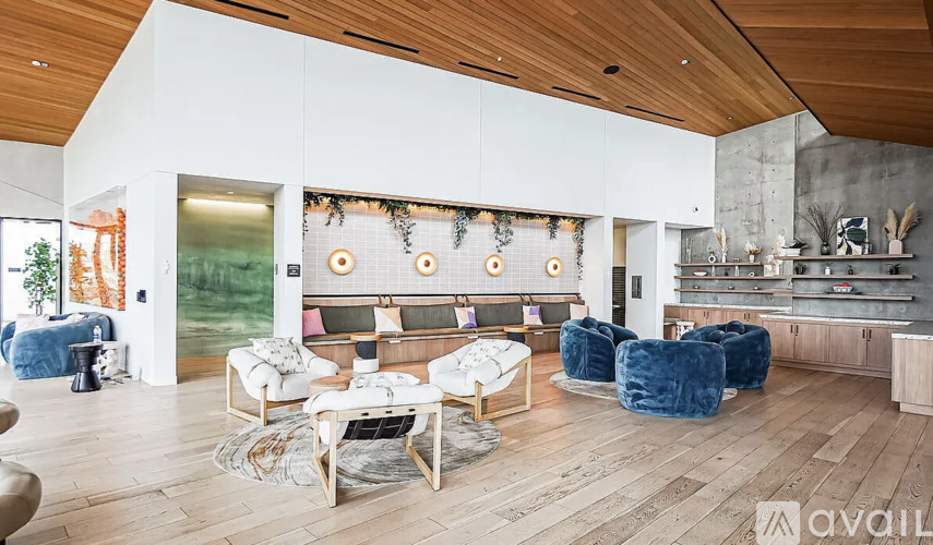 A living room with a white couch and a wooden floor.