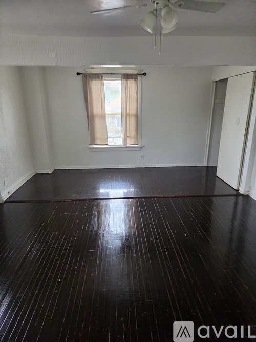 A room with a window and a ceiling fan.