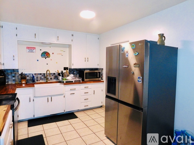 A kitchen with a fridge and a counter.