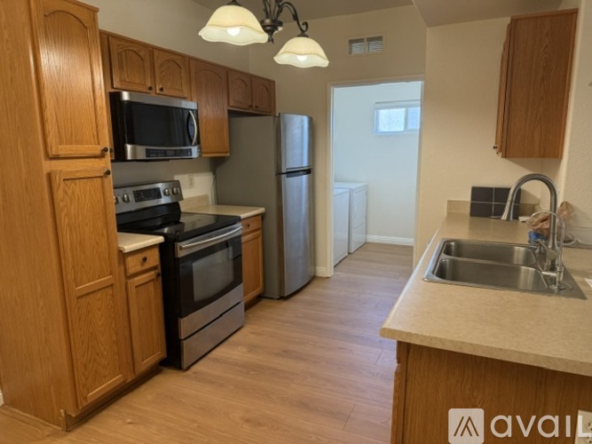 A kitchen with wooden cabinets and stainless steel appliances.