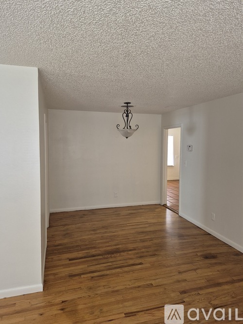 A room with wooden floors and a chandelier.