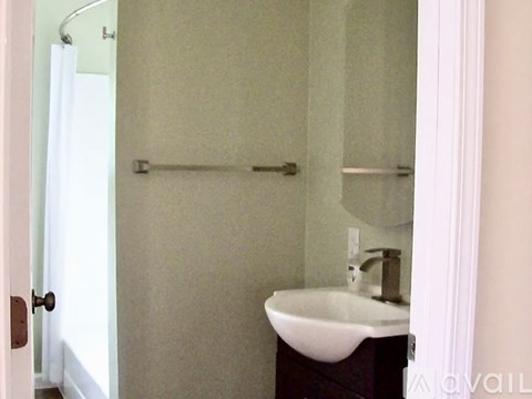 A bathroom with a sink and a shower.