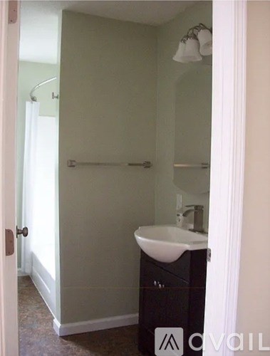 A bathroom with a sink and a shower.