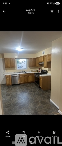 A kitchen with wooden cabinets and a window.
