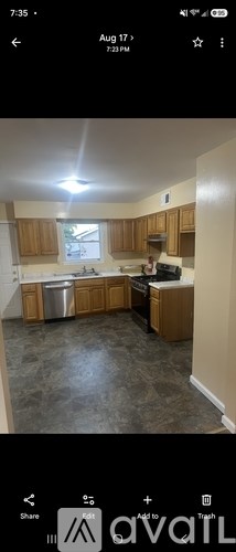 A kitchen with wooden cabinets and a window.