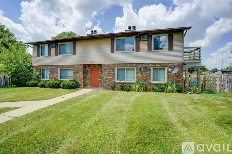 A house with a red door is for sale.