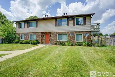 A house with a red door is for sale.