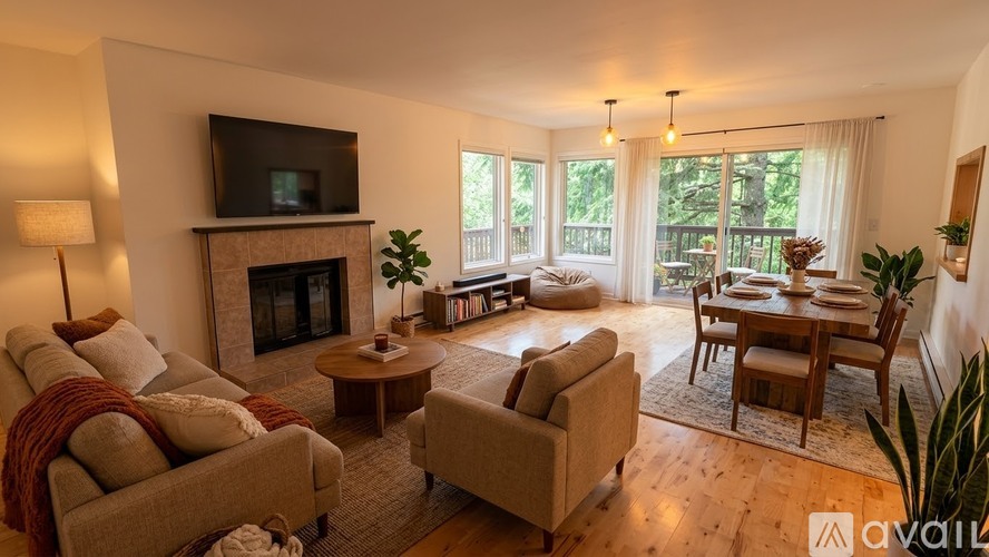 A living room with a fireplace and a television on the wall.