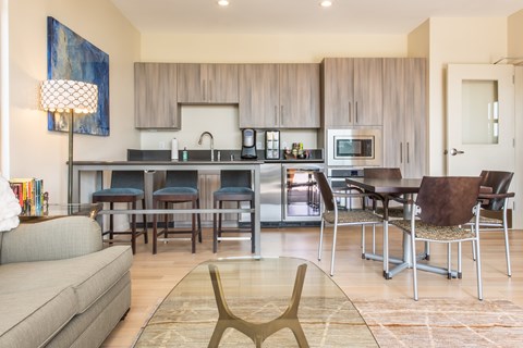 A modern kitchen with a dining table and chairs.