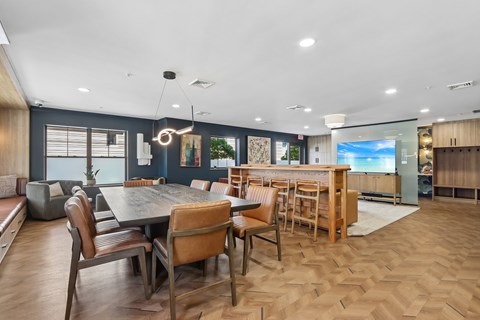 A modern dining room with a wooden table and chairs.
