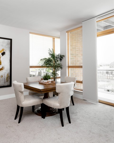 A dining room with a table and chairs.