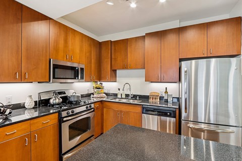 A kitchen with wooden cabinets and stainless steel appliances.