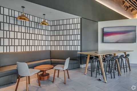 A modern dining area with a wooden table and chairs.