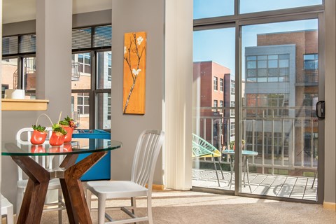 A dining room with a glass table and chairs.