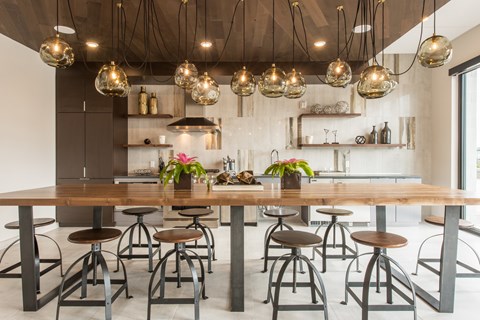 A modern dining area with a long table and chairs.