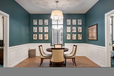 A dining room with a table set for four.