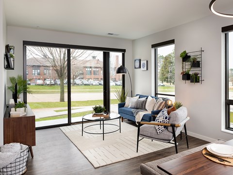 A living room with a blue couch and a coffee table.