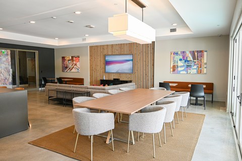 A conference room with a long table and chairs.
